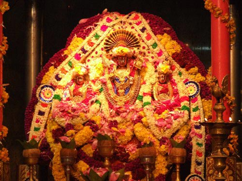 God Śrī Sivasubramaniya Swamy, and Goddesses Valli Ammai and Thivaiyanai are decorated with fresh flowers and silk for the festival