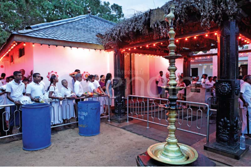 A crowd with pooja vattis gathers at the Kataragama Maha Devalaya