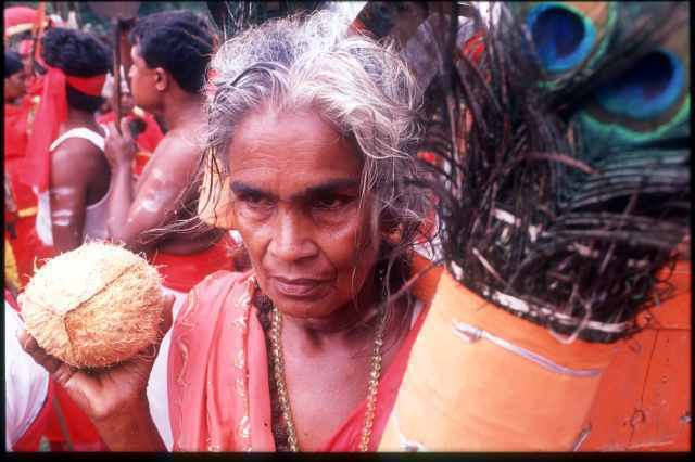 Devotee with feathers & coconut